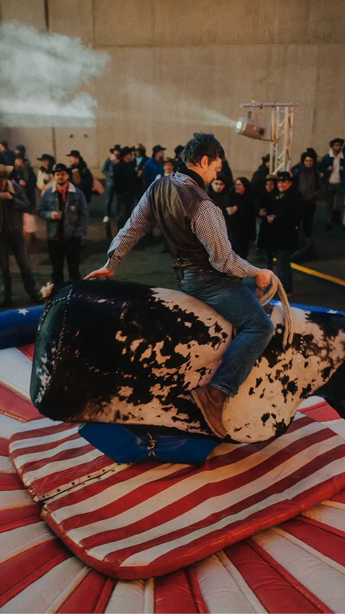 a freiheit.com member gives their best at bull riding at the xmas party 2025